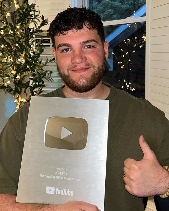 George Michael holding a YouTube play button award